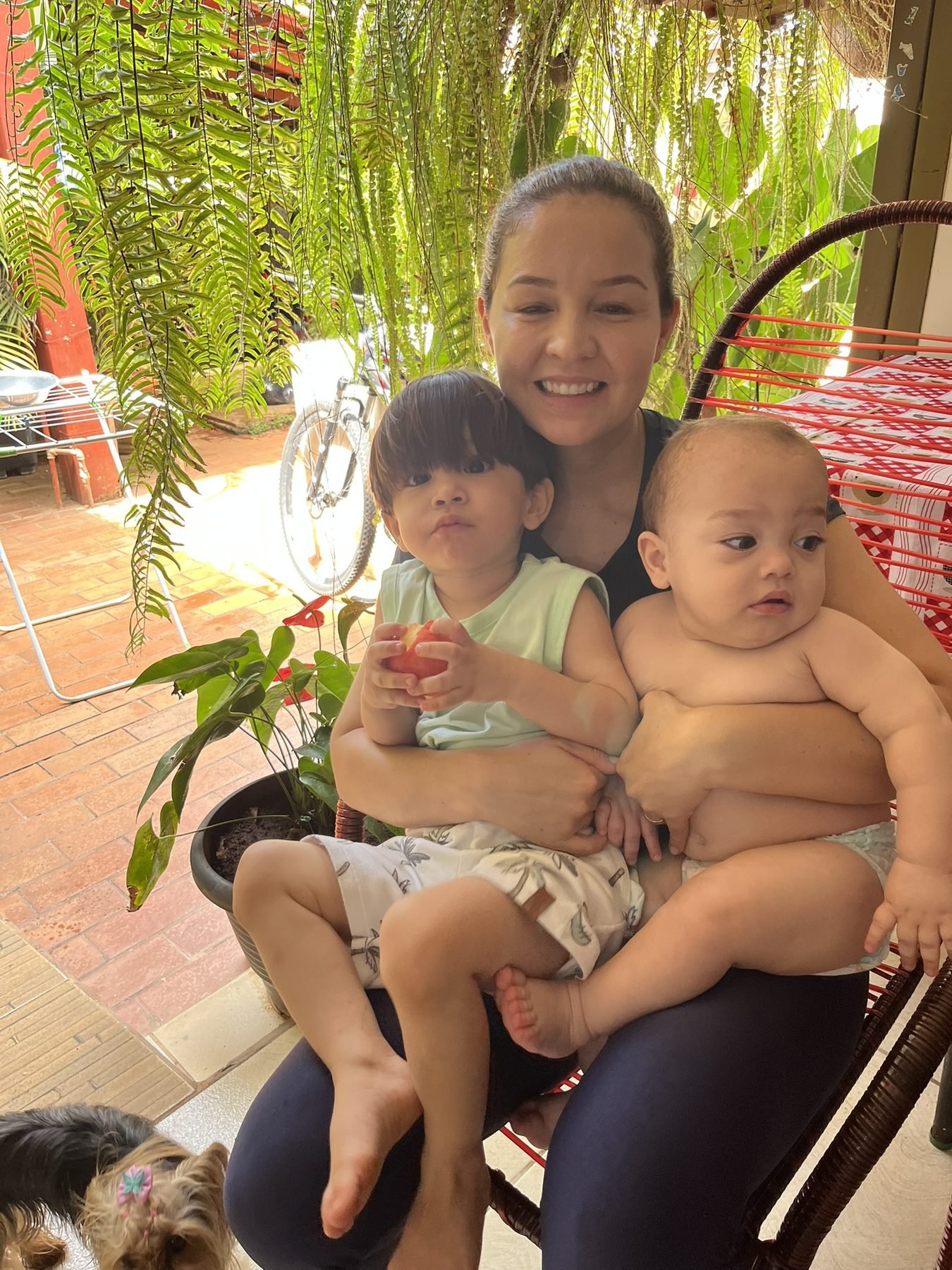 Nordana com os dois filhos no colo, e a Amorinha no canto